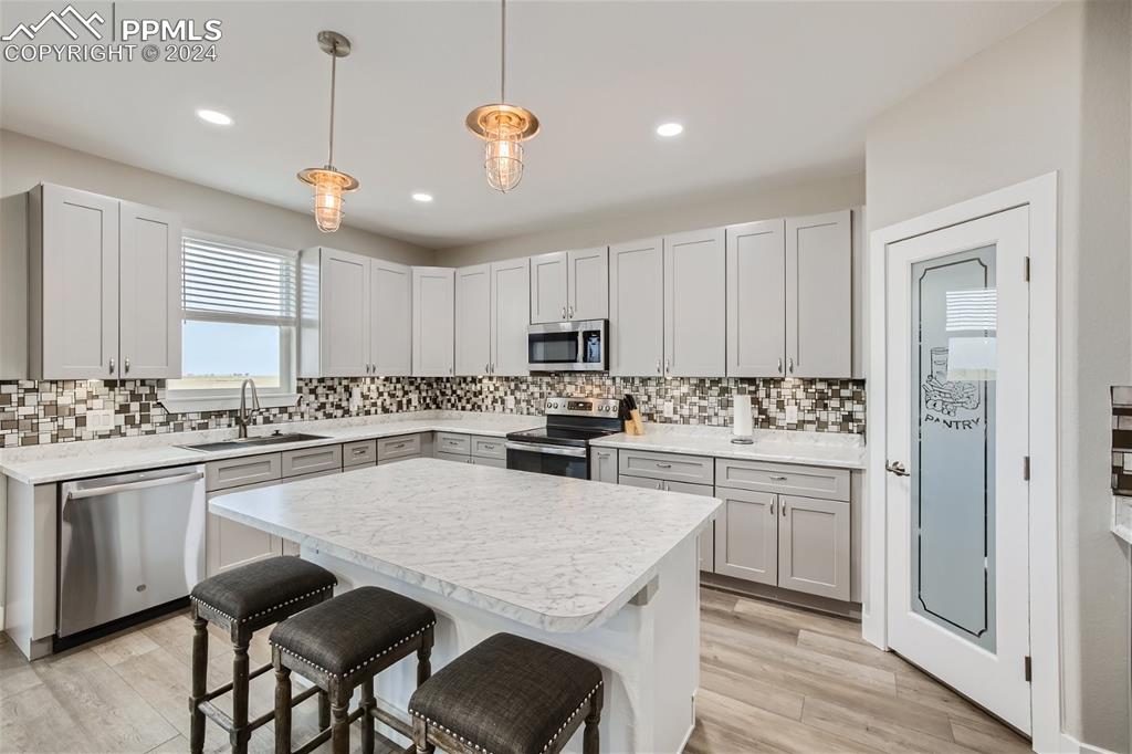 3755 North Rush Road Rush, CO 80833 - Photo 8 of 26 a kitchen with a center island a sink stainless steel appliances and cabinets