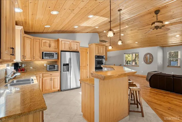 a view of a dining room with furniture large windows and wooden floor