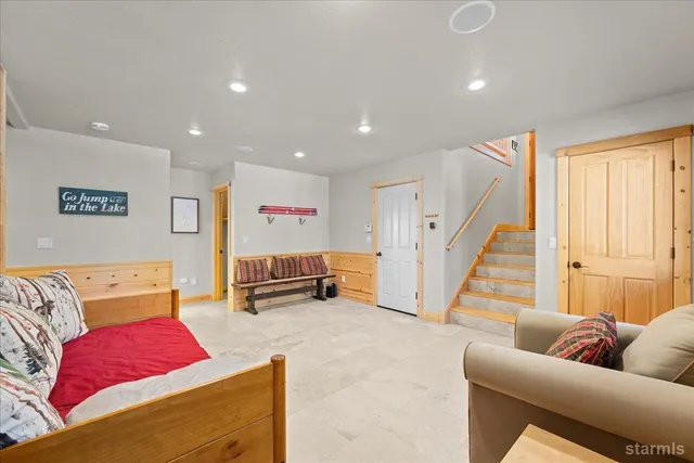 a bedroom with a large bed and a dresser