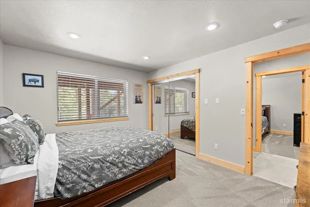 a bedroom with a large bed and a window