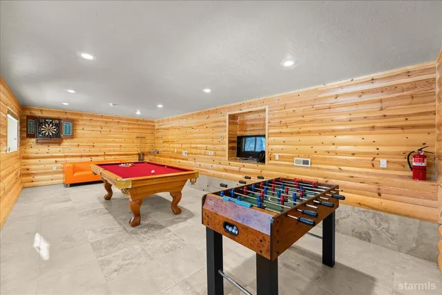a room with pool table and furniture