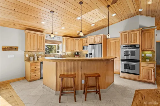 a kitchen with cabinets and chairs