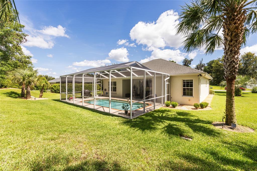 19639 Southwest 77th Loop Dunnellon, FL 34432 - Photo 49 of 59 a view of a house with a yard patio and fire pit