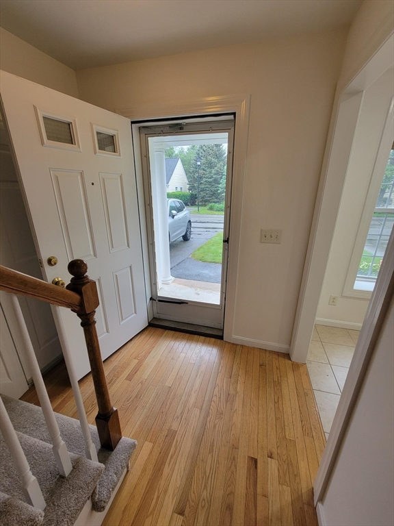 281 Rowley Bridge Road, Unit 7 Topsfield, MA 01983 - Photo 11 of 32 a view of a hallway with wooden floor and stairs