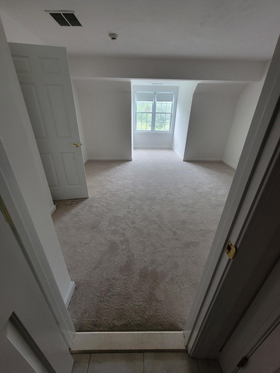 281 Rowley Bridge Road, Unit 7 Topsfield, MA 01983 - Photo 18 of 32 a view of an empty room with a window