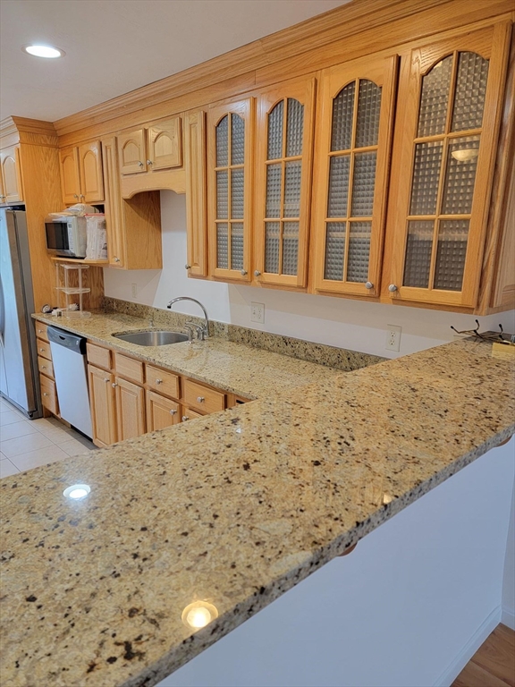 281 Rowley Bridge Road, Unit 7 Topsfield, MA 01983 - Photo 19 of 32 a view of a kitchen with granite countertop cabinets sink and a granite counter top