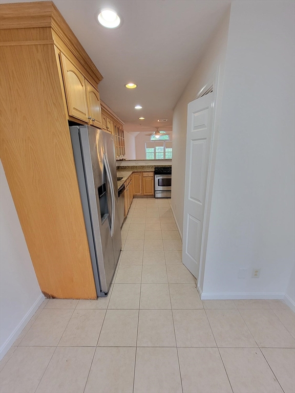 281 Rowley Bridge Road, Unit 7 Topsfield, MA 01983 - Photo 22 of 32 a view of a kitchen with refrigerator and a stove