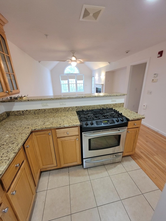 281 Rowley Bridge Road, Unit 7 Topsfield, MA 01983 - Photo 5 of 32 a kitchen with granite countertop a stove and a sink