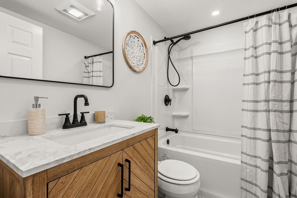 74 Magnolia Street Braintree, MA 02184 - Photo 24 of 35 a bathroom with a sink a toilet and a shower