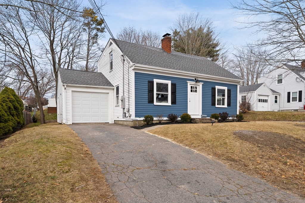 74 Magnolia Street Braintree, MA 02184 - Photo 3 of 35 a front view of a house with a yard and garage
