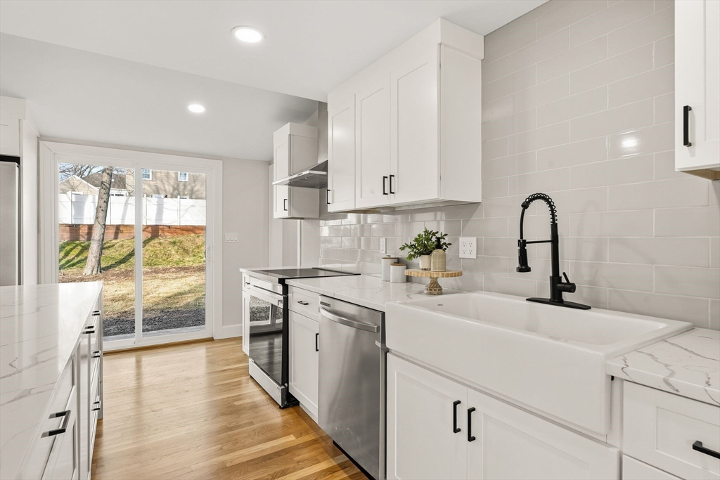 74 Magnolia Street Braintree, MA 02184 - Photo 10 of 35 a kitchen with a sink white cabinets and appliances