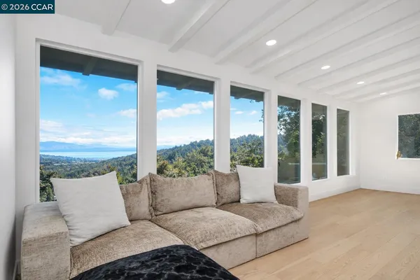a living room with furniture and large windows