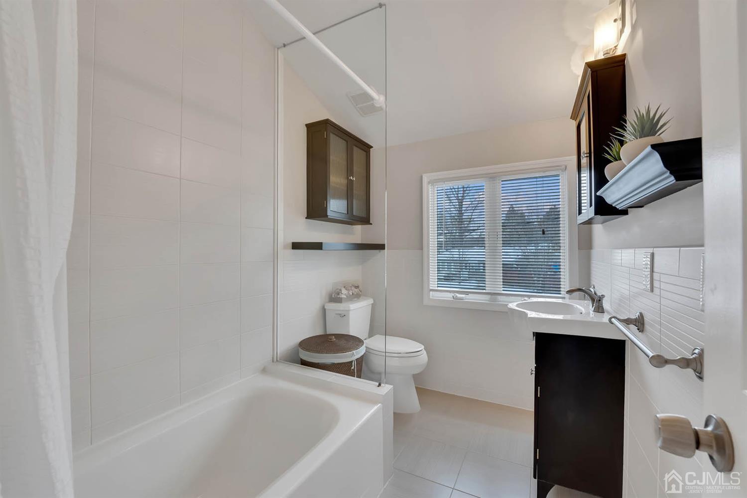 3032 Cheesequake Road Old Bridge, NJ 08859 - Photo 11 of 28 a bathroom with a sink and a bathtub