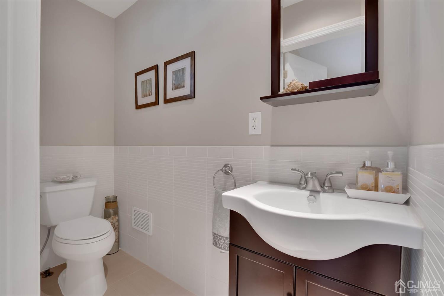 3032 Cheesequake Road Old Bridge, NJ 08859 - Photo 13 of 28 a bathroom with a toilet a sink and mirror
