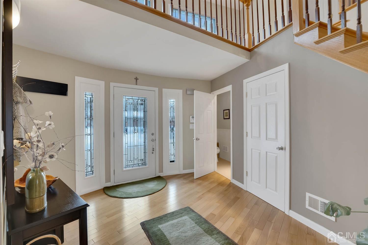 3032 Cheesequake Road Old Bridge, NJ 08859 - Photo 10 of 28 a view of a hallway with wooden floor and a living room