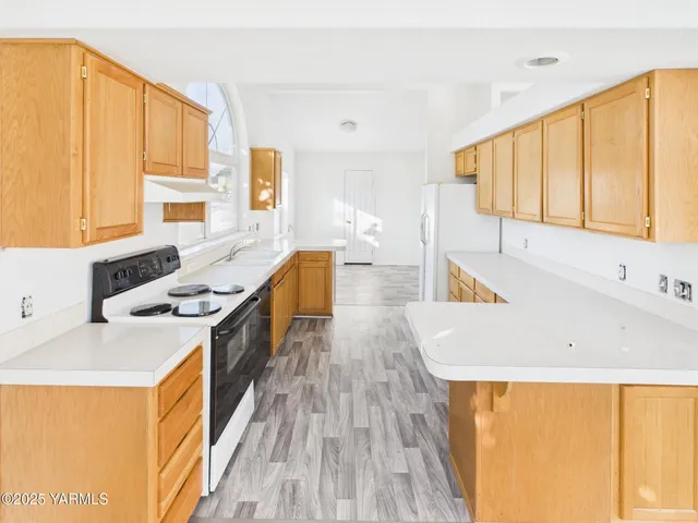 a kitchen with a sink a stove and a refrigerator
