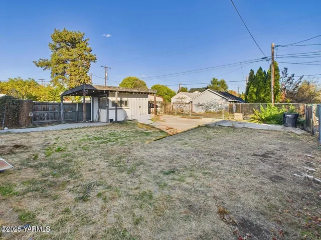 a view of a large house with a yard and potted plants