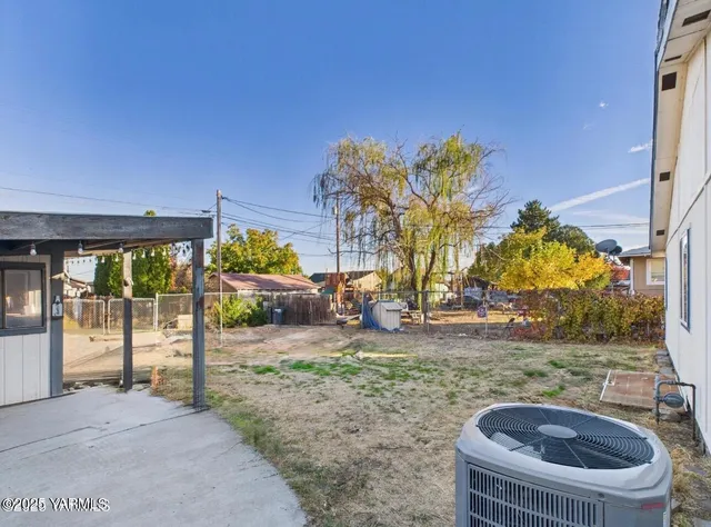 a backyard of a house with table and chairs