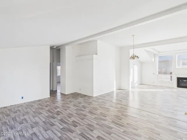 a view of an empty room and wooden floor