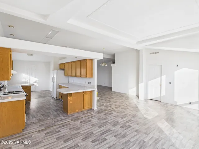 a view of a living room kitchen and a sink