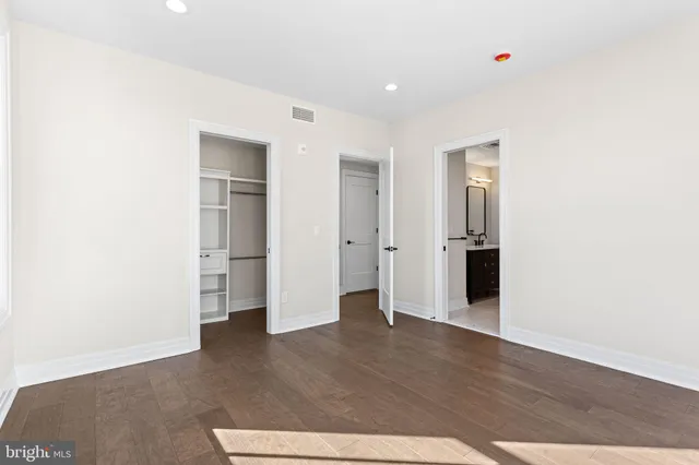 a view of walk in closet with empty racks