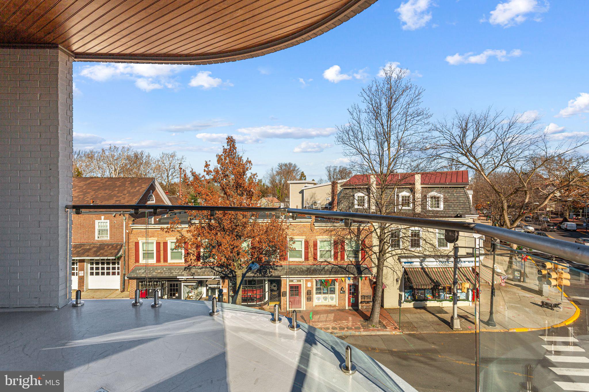 151 Kings Highway East, Unit A Haddonfield, NJ 08033 - Photo 23 of 24 a view of a balcony with dining table and chairs with wooden floor