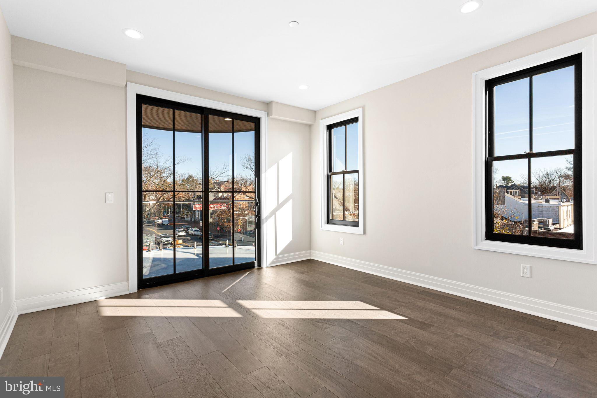 151 Kings Highway East, Unit A Haddonfield, NJ 08033 - Photo 9 of 24 an empty room with wooden floor and windows
