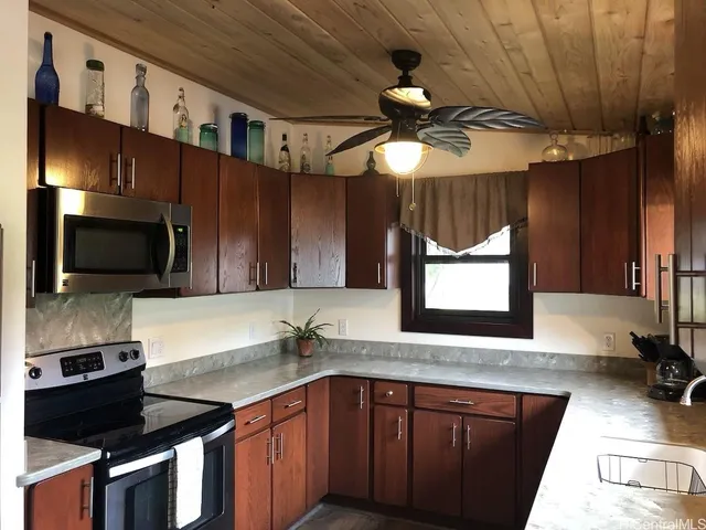 a stove top oven sitting inside of a kitchen