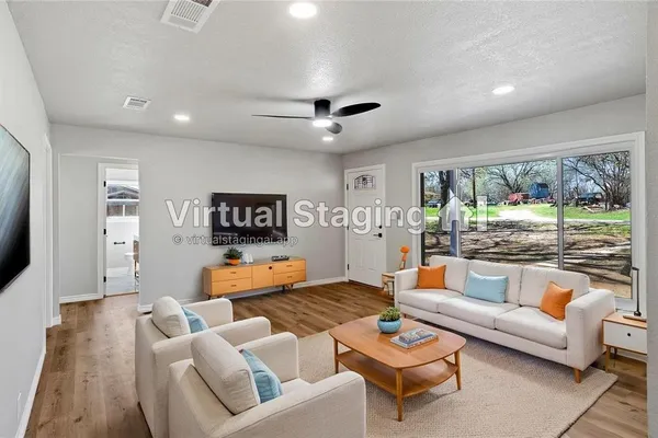 a living room with furniture and a flat screen tv