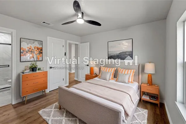 a bedroom with furniture and a flat screen tv