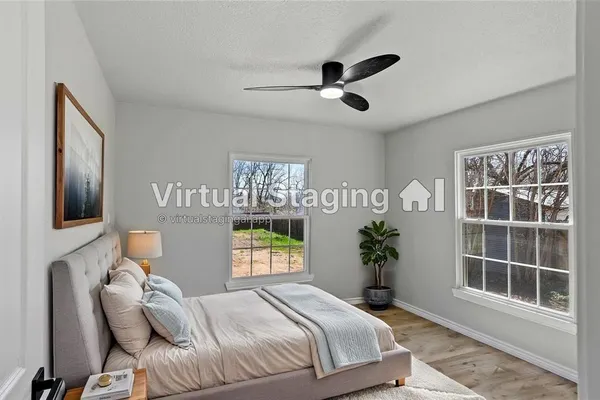 a bedroom with a bed and a window