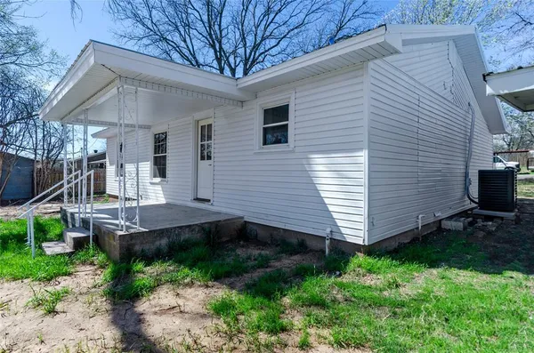 a view of a house with a yard and furniture
