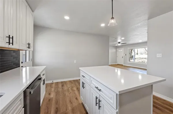 a kitchen with a sink a stove a microwave and a refrigerator
