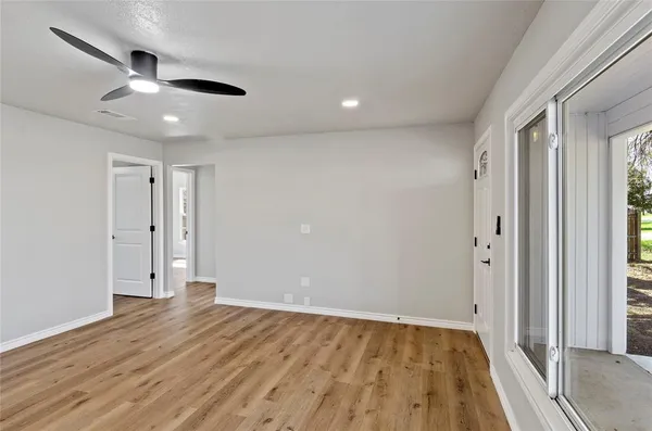 wooden floor in an empty room with a window