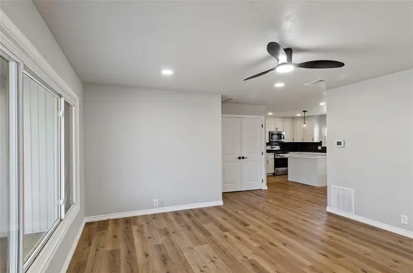 a view of kitchen with refrigerator microwave and stove