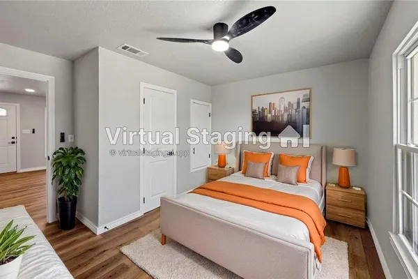 a bedroom with a balcony a bed and a potted plant