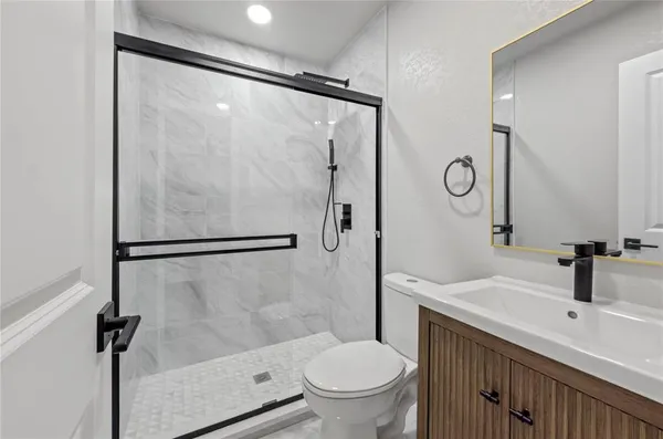 a bathroom with a sink toilet and shower