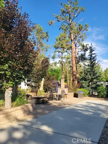 a view of road with a building and trees in the background