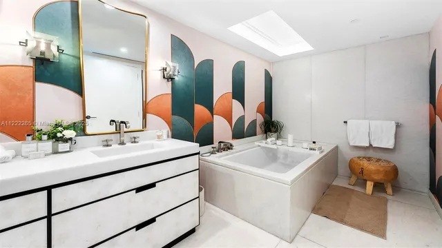 a bathroom with a sink and mirror with toilet