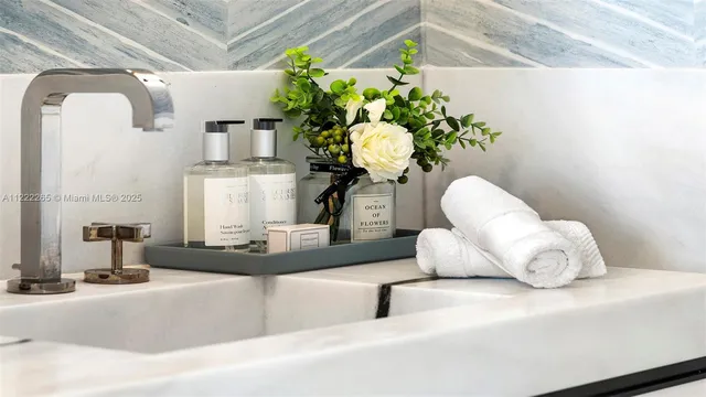a bathroom with a granite countertop double vanity and a mirror