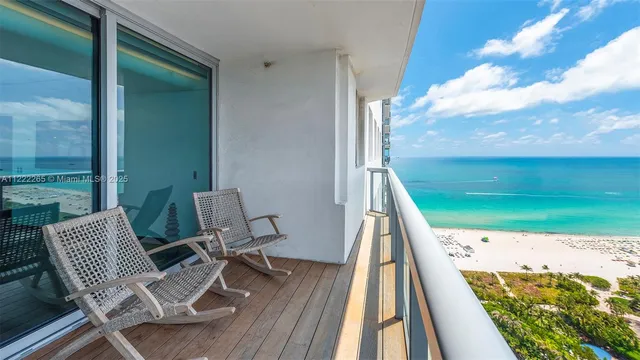 a view of balcony with a potted plant and floor to ceiling window
