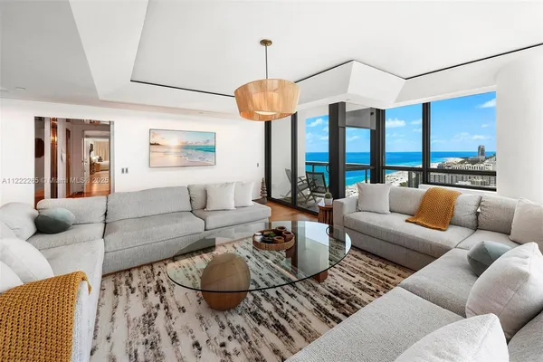 a living room with furniture and a chandelier
