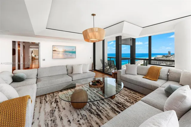 a living room with furniture and a chandelier