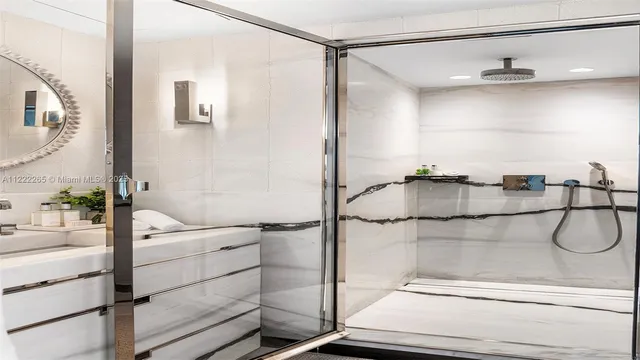 a bedroom with a bed and large windows