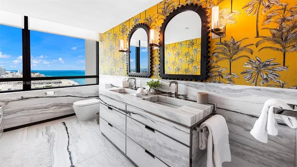 a bathroom with a tub and a large window