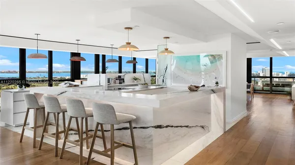 a dining hall with stainless steel appliances kitchen island granite countertop a stove and cabinets