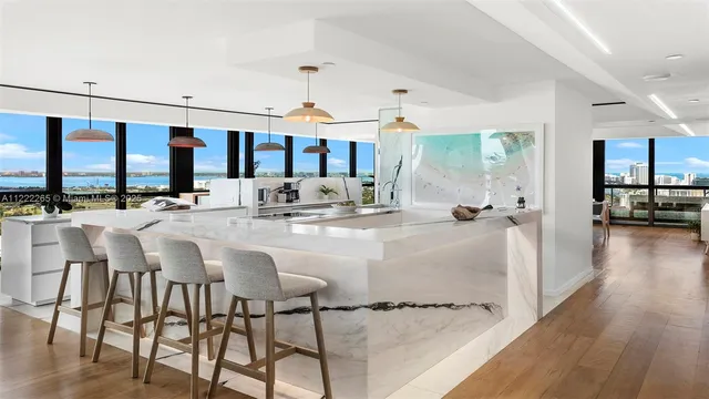 a dining hall with stainless steel appliances kitchen island granite countertop a stove and cabinets