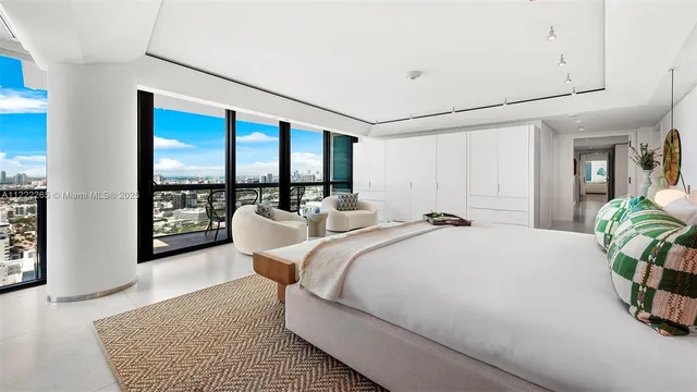 a bed room with a bed and a large window