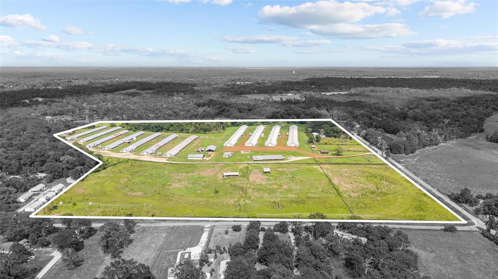 3216 Old Ewing Road Lufkin, TX 75901 - Photo 1 of 24 Expansive agricultural property featuring multiple poultry houses, extensive open land, and perimeter fencing