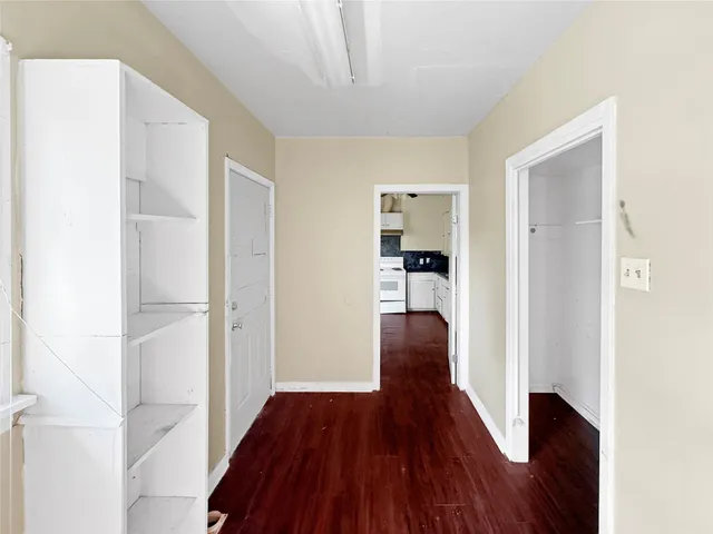a view of hallway with wooden floor